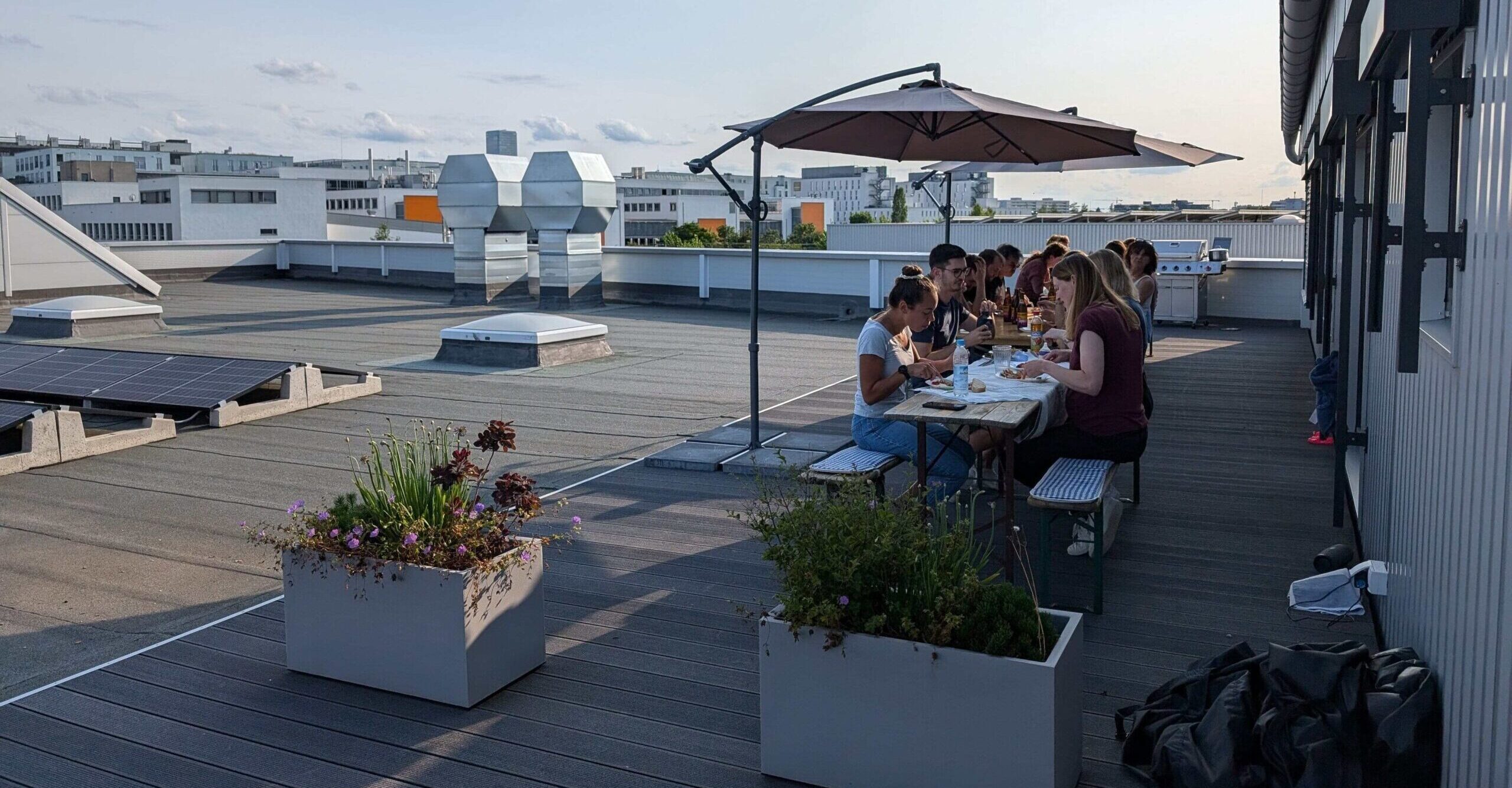 The team having dinner together on the office roof terrace in Munich